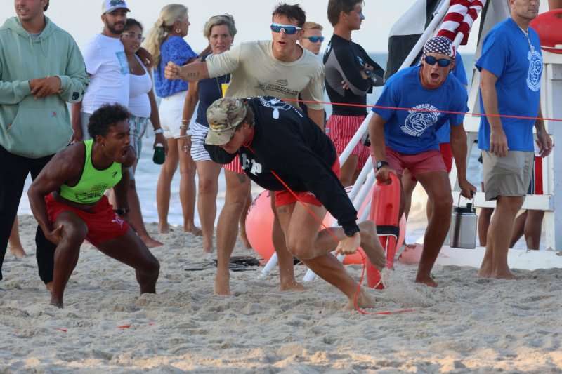 Will Shoemaker of Rehoboth Beach Patrol gets encouragement during the landline competition. Shown behind Shoemaker are (l-r) Sgt. Jodi Johnson, Konner Knarr and Lt. Rawley Florax.